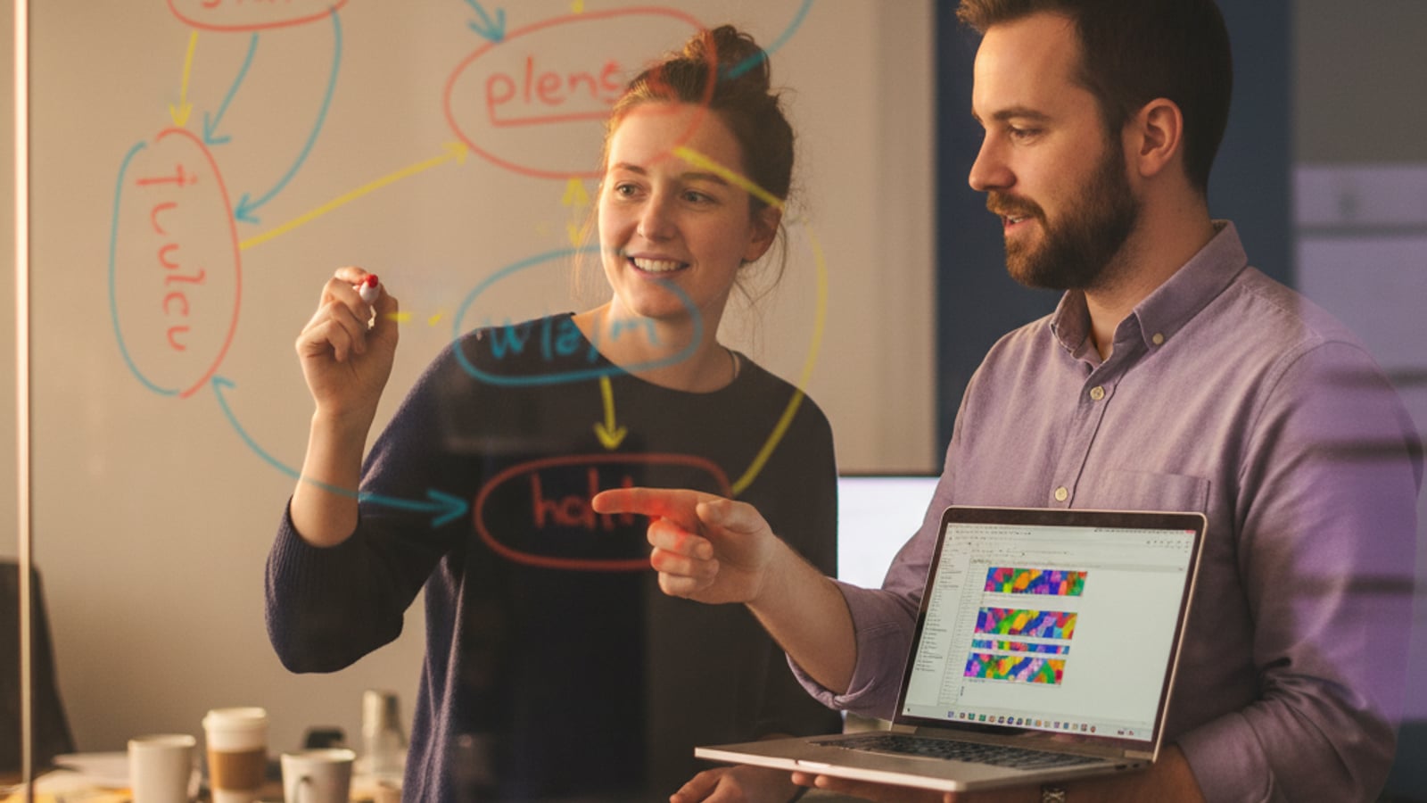 Two engineers collaborate at a whiteboard, sketching abstract state machine concepts for n8n state machine extraction to typescript.